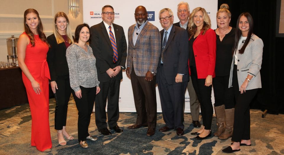 Faculty and staff posing with NFL legend Emmitt Smith at the Trends Conference