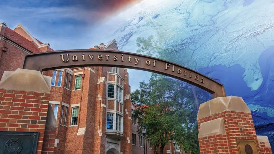 The University of Florida gateway with Heavener Hall in the background and the earth with Florida visible transposed in the sky