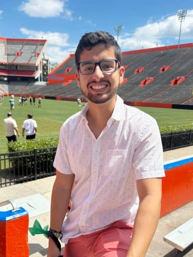 Jose Mayorca in the UF stadium with the football field in the background