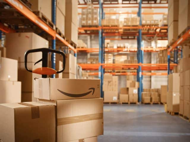 Inside a warehouse with lots of boxes and an Amazon logo on one box