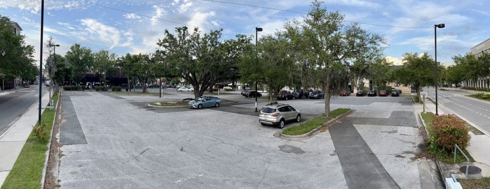 A parking lot in downtown Gainesville with a lot of empty spaces