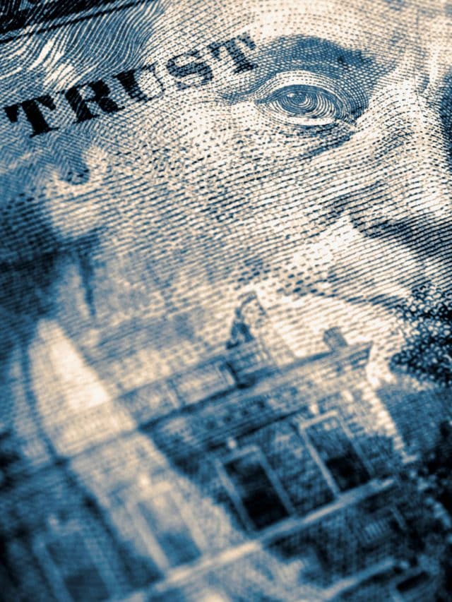 The word 'trust' stamped on a dollar bill close up