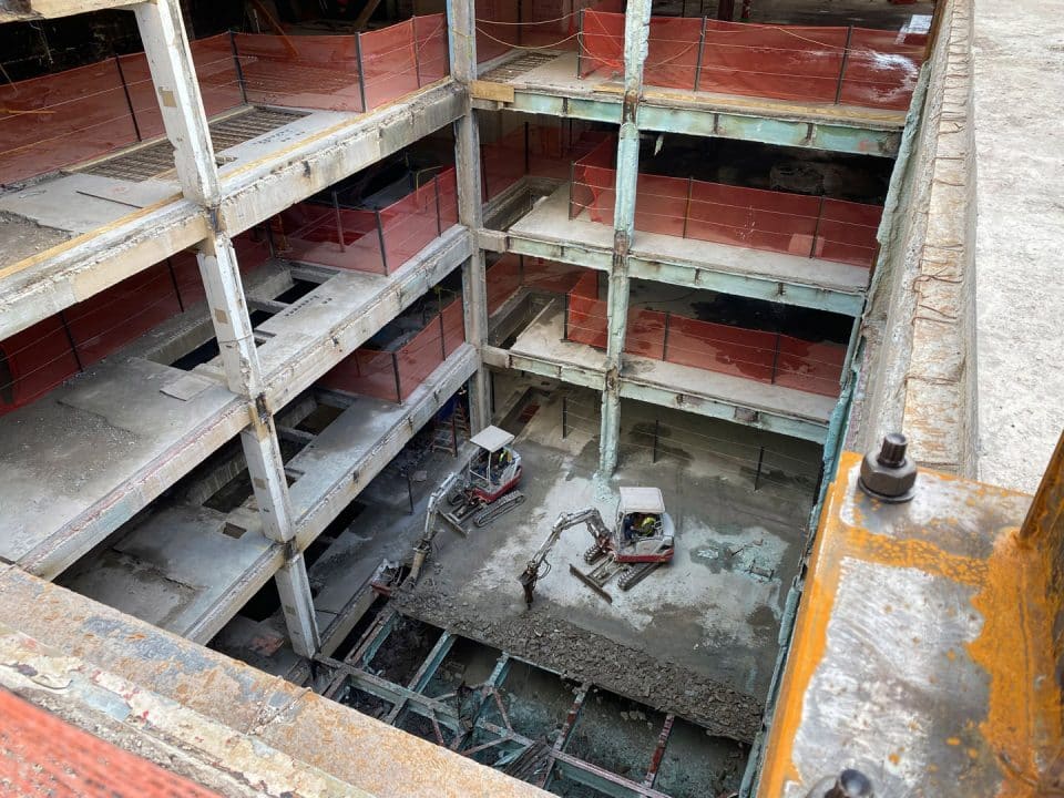 Looking down on construction equipment in the middle of a stripped out building