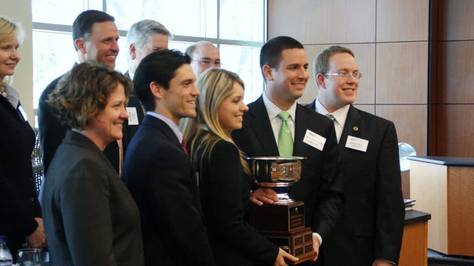 Case competition team holds their trophy