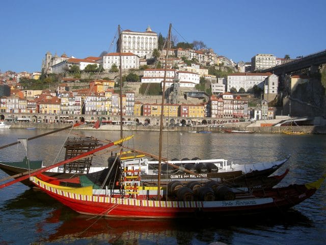 Boats on the Douro River with buildings in the background in Porto, Portugal