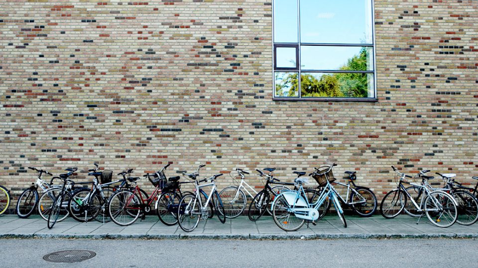 Bicycles parked along a building in Aarhus, Denmark
