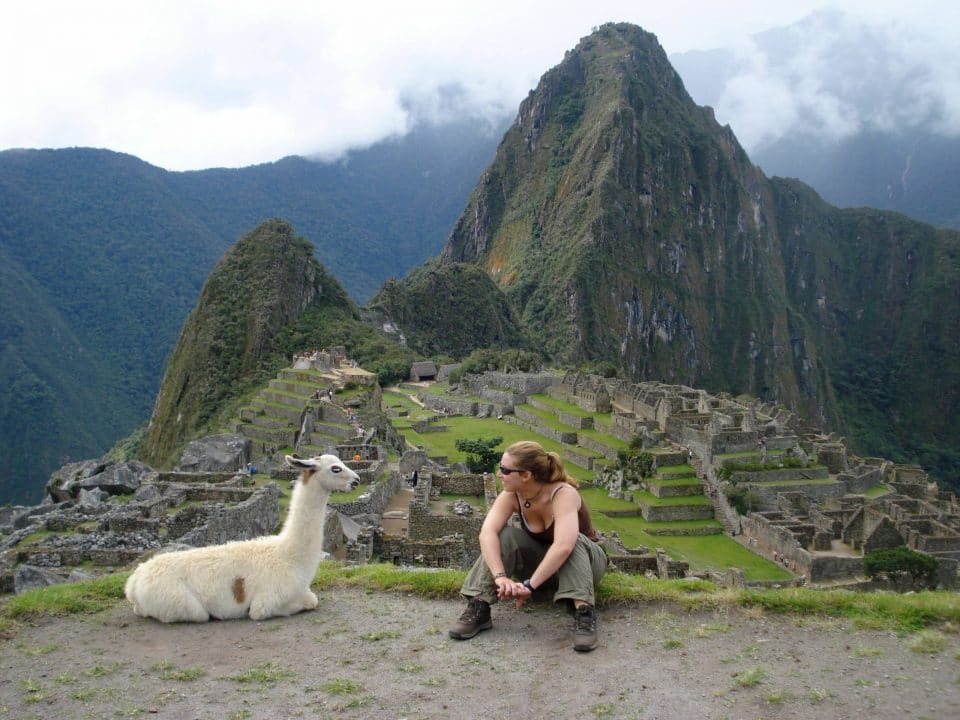An alpaca and a young woman at Machu Picchu, Peru