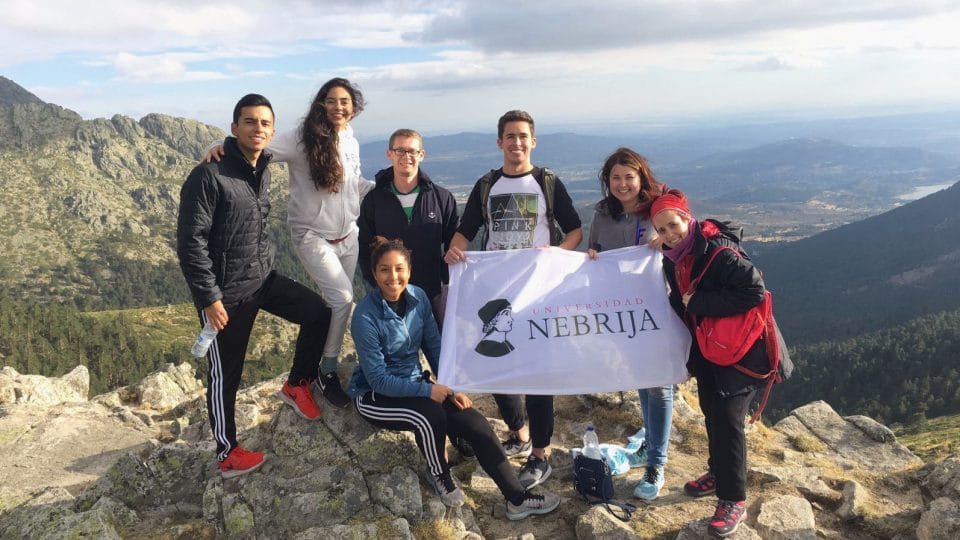 Student group holding sign at the top of Navacerrada Mountain Pass.
