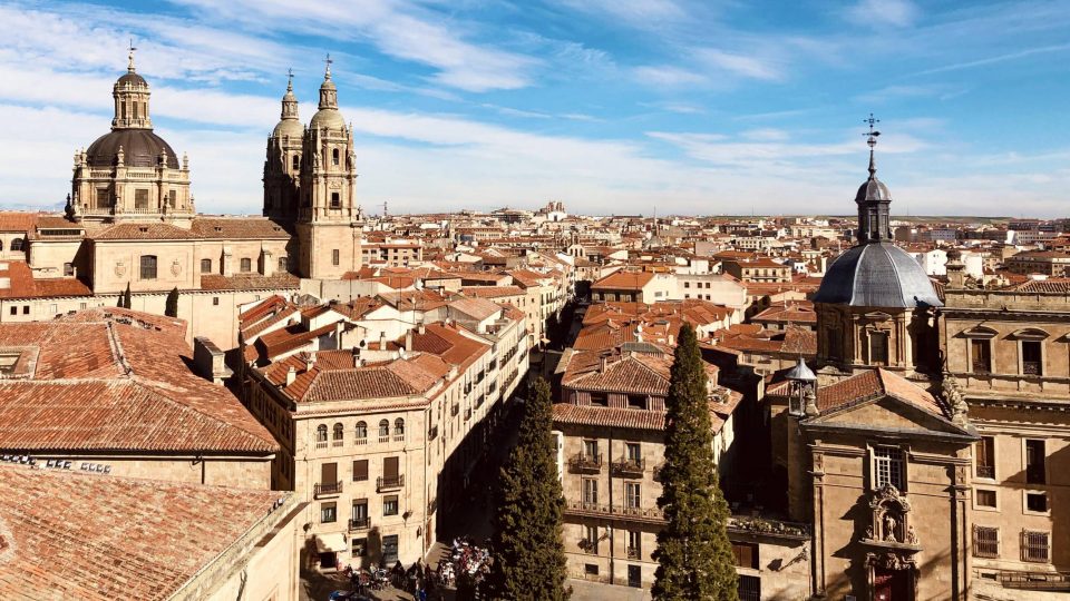 Rooftop view of the city of Salamanca Spain with a clear sky in the background.