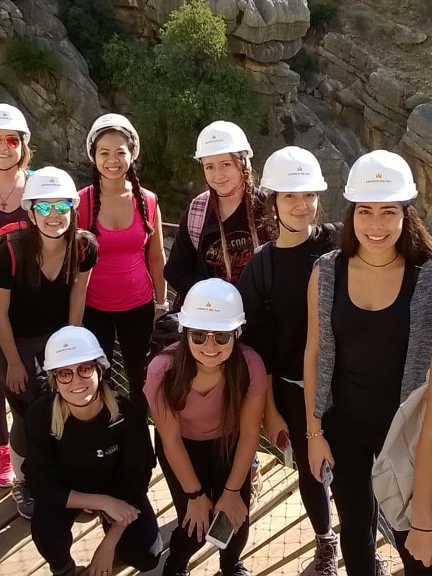 Group hiking with helmets in mountains of Asturias, Spain.