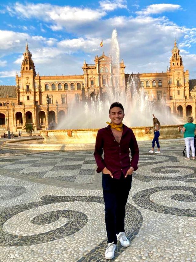 Student in front of fountain at Plaza de Espana in Seville, Spain.